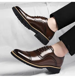 Classic brown leather business dress shoes for men featuring elegant brogue detailing