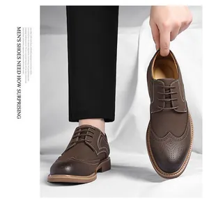 Classic brown men's Brogue dress shoes with wingtip detailing and lace-up closure