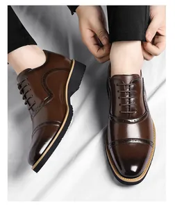 Close-up view of brown men's leather Oxford shoes featuring cap toe and brogue detailing