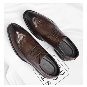 Detail of brown crocodile-embossed leather dress shoes for formal weddings.