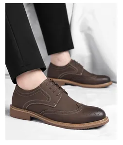 Detailed macro view of men's brown leather brogue wingtip dress shoes with lace-up