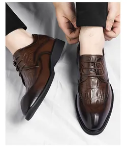 Detailed view of elegant men's brown crocodile embossed leather formal dress shoes
