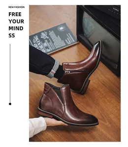 Detail view of brown leather Chelsea boots with side zipper and elastic panel
