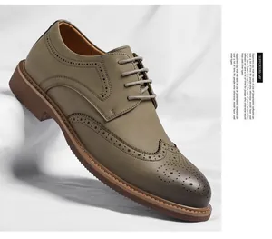 Macro view of khaki men's business brogue dress shoes with classic wingtip carving