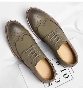 Overhead view of men's olive green wingtip brogue dress shoes with lace-up detail