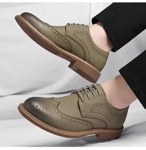 Detailed view of men's olive green wingtip brogue oxfords featuring elegant carving patterns