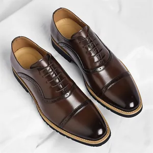 Elegant men's dark brown cap-toe oxford shoes with brogue details for business wear