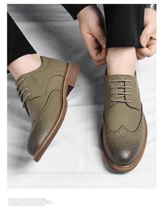 Detail showing olive green Brogue dress shoes with intricate carved leather patterns