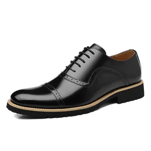 Elegant black leather men's cap-toe business oxford shoes with brogue detailing.