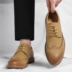 Men's tan Brogue business shoes with carved wingtip detail and lace-up closure