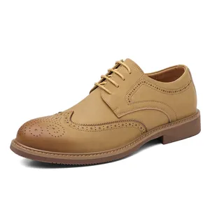 Tan British style brogue dress shoes for men with elegant wingtip carving