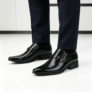 Detail view of men's black leather loafers with metal buckle and striped texture