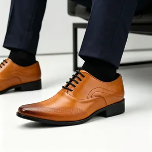 Close-up of tan leather oxford shoes featuring intricate brogue perforated toe detail