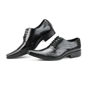 Close-up view of black leather men's business dress shoes with detailed textured toe