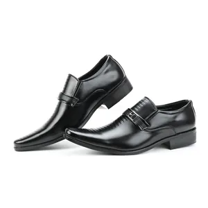 Detailed view of black men's business loafers with decorative buckles and embossed vamp.