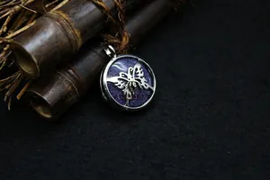 Close-up of the intricately designed butterfly cutout pendant with a blue glitter inlay