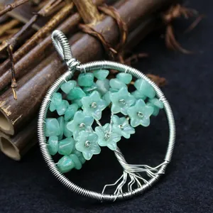 Handmade silver wire-wrapped Tree of Life pendant with green crystal stone chips.