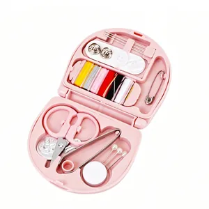 Compact pink portable travel sewing kit with multi-colored threads and essential tools