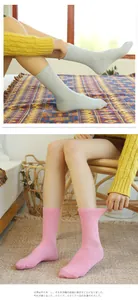 Close-up of pink and light blue cotton crew socks worn on legs for a comfortable fit.