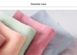 Macro view showing the fine ribbed texture of soft pastel colored low cut cotton socks.