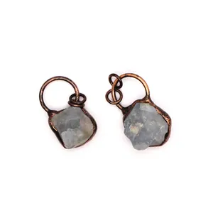 Detailed macro shot of raw fluorite crystal pendants with vintage copper wire wrapping