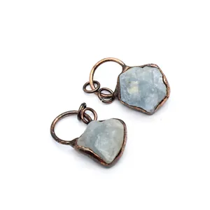 Macro detail of natural raw fluorite stone pendants with vintage copper plating frames