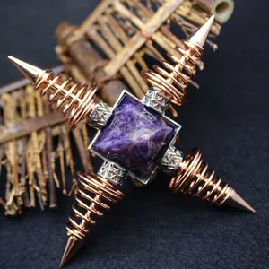 Rose gold metallic spring pyramid ornament featuring a purple amethyst crystal gemstone center