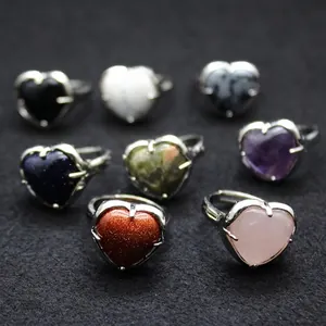 Collection of minimalist heart-shaped crystal rings with gold sandstone and rose quartz stones