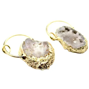 Pair of irregular natural agate crystal pendants with gold plated edging on white back