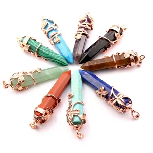 Set of natural crystal hexagonal column pendants with rose gold flower filigree decoration.