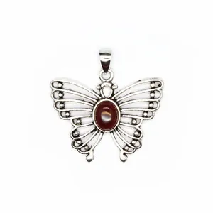 Close-up of butterfly pendant with oval reddish-brown stone and silver hollowed design
