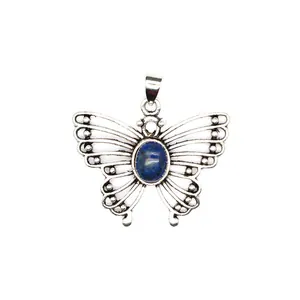 Detailed close-up view of a vintage butterfly pendant with blue natural stone inlay in silver
