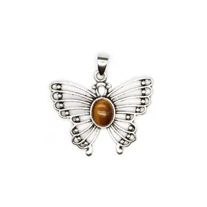 Detail shot of an antique silver butterfly pendant with oval tiger eye stone inlay.