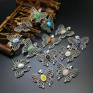 Detailed view of assorted natural stone butterfly pendants in various vibrant and rich colors