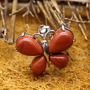 Natural red stone butterfly pendant necklace charm with rustic background elements