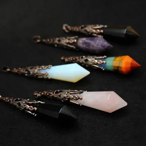 Vintage hexagonal crystal pillar pendulum pendants with ornate copper caps for dowsing.