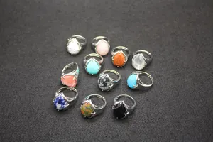 Detailed view of various teardrop-shaped natural stone open rings in different colors.