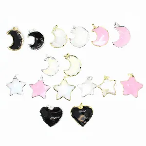Detailed view of various opal-like star moon and heart shaped pendants with metal edges