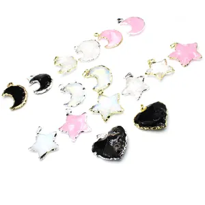 Close-up view of assorted opalite and resin star, moon, and heart pendants for jewelry making