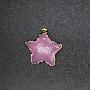 Close-up of a pink star-shaped opal pendant with an elegant gold-plated edge finish.