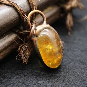 Handcrafted irregular raw citrine crystal stone pendant featuring a vintage copper frame