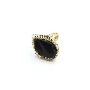 Close-up detail of a vintage style wire-wrapped ring featuring a large black raw stone