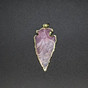 Detail view of arrowhead-shaped purple opalite pendant with gold electroplated edge