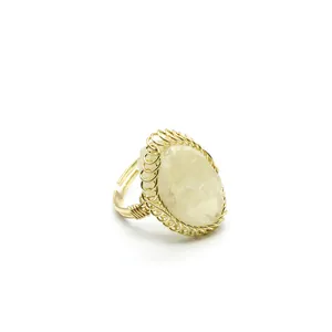 Detailed view of handmade gold wire-wrapped ring with natural raw gemstone