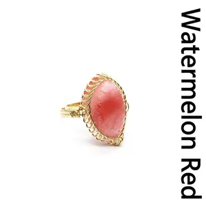 Detail of medieval retro ring with a watermelon red druzy stone in gold wire wrap