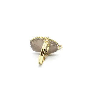 Close-up of a vintage handmade raw crystal ring with adjustable gold wire band