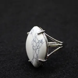 Silver-plated adjustable ring featuring a large marquise-cut white turquoise stone.