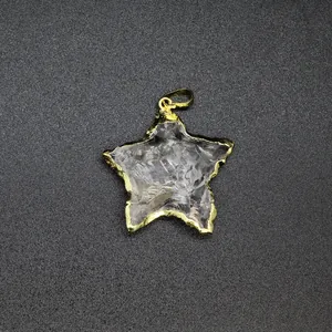 Detailed macro view of a star-shaped clear stone pendant with gold-plated textured edges
