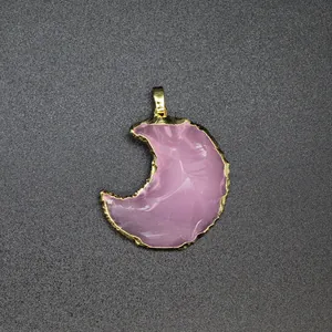 Detailed close-up of pink opalite moon pendant with gold electroplated textured edges