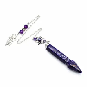 Detailed view of an amethyst crystal pendulum with a hexagram and dreamcatcher charm.